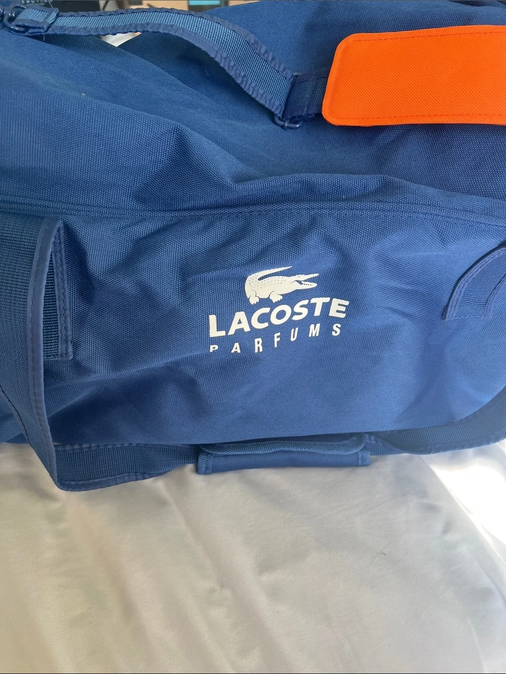 Lacoste Navy Duffel Bag with Orange Strap Accent